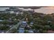 Aerial view of neighborhood featuring a home with mature tree coverage and close proximity to the water at 1629 Siesta Dr, Sarasota, FL 34239