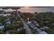 Aerial view of home showing location close to the water with mature landscaping and tree coverage at 1629 Siesta Dr, Sarasota, FL 34239