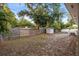 This backyard features a shed, privacy fence, and a concrete patio with outdoor dining area at 1629 Siesta Dr, Sarasota, FL 34239
