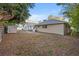 Spacious backyard featuring a shed, privacy fence, and a concrete patio with outdoor dining area at 1629 Siesta Dr, Sarasota, FL 34239