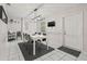 The dining room has a white table, black chairs, a modern light fixture, and white floors at 1629 Siesta Dr, Sarasota, FL 34239