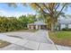Charming single-story home with a light gray roof, covered parking, and a well-maintained landscaped front yard at 1629 Siesta Dr, Sarasota, FL 34239