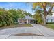 Inviting one-story home with a lush tropical landscape and a convenient covered carport space at 1629 Siesta Dr, Sarasota, FL 34239
