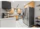 This kitchen boasts stainless steel appliances, wooden cabinets, and tile floors at 1629 Siesta Dr, Sarasota, FL 34239