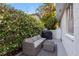 Relaxing outdoor patio area surrounded by lush greenery with comfortable couch and outdoor furniture at 1629 Siesta Dr, Sarasota, FL 34239