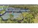 Elevated view showcasing well-maintained tennis courts in a lush landscape at 17324 Sandpearl Rd, Venice, FL 34293