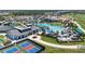 Stunning aerial view of community amenities including pool, tennis courts, and clubhouse at 17324 Sandpearl Rd, Venice, FL 34293