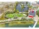 Aerial view of the community playground, parking lot, and lakeside location with beautiful surroundings at 17324 Sandpearl Rd, Venice, FL 34293
