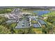 Aerial view of community amenities with pool, clubhouse, and various sports courts at 17324 Sandpearl Rd, Venice, FL 34293