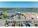 Scenic aerial view featuring a golf course and lake at 17324 Sandpearl Rd, Venice, FL 34293