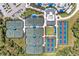 Overhead view of tennis courts in the community, featuring both green and red-clay courts at 17324 Sandpearl Rd, Venice, FL 34293