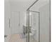 Bathroom featuring a glass shower and gray cabinetry at 17324 Sandpearl Rd, Venice, FL 34293