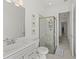 Bathroom featuring a glass shower and gray cabinetry at 17324 Sandpearl Rd, Venice, FL 34293