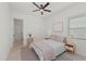 Bedroom featuring a ceiling fan, light colored walls, and a gray patterned area rug at 17324 Sandpearl Rd, Venice, FL 34293