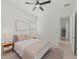 Bedroom featuring a ceiling fan, light colored walls, and a gray patterned area rug at 17324 Sandpearl Rd, Venice, FL 34293