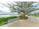 Scenic common area with seating, landscaping, and a picturesque lake view, offering a relaxing community space at 17324 Sandpearl Rd, Venice, FL 34293