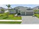 Charming single-story home featuring a tile roof, a two-car garage, and meticulously landscaped front yard at 17324 Sandpearl Rd, Venice, FL 34293