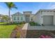 Charming single-story home with a well-manicured lawn and a welcoming double door entrance at 17324 Sandpearl Rd, Venice, FL 34293