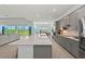 Contemporary kitchen featuring a large island, stainless appliances, and open layout at 17324 Sandpearl Rd, Venice, FL 34293