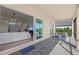 Relaxing covered patio with stylish furniture and views of the lush backyard at 17324 Sandpearl Rd, Venice, FL 34293
