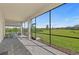 Screened-in patio with ample seating and a serene view of the lush backyard and green space at 17324 Sandpearl Rd, Venice, FL 34293