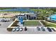 Aerial view of clubhouse, bocce ball court, and pool on a sunny day at 17324 Sandpearl Rd, Venice, FL 34293