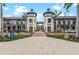 Commercial buildings with twin towers are connected by a skywalk, plus palm trees and walkable street at 17324 Sandpearl Rd, Venice, FL 34293