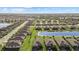 Expansive aerial view of a community boasting well-manicured lawns and serene water features, offering a peaceful neighborhood setting at 2000 Gardenia Ave, Port Charlotte, FL 33953