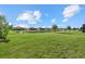 Lush backyard featuring a pond, well-maintained lawn, and neighborhood views at 2000 Gardenia Ave, Port Charlotte, FL 33953