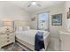 Well lit bedroom with decorative artwork and a ceiling fan, creating a cozy and inviting atmosphere at 2000 Gardenia Ave, Port Charlotte, FL 33953