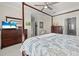 Spacious bedroom with a four-poster bed, two dressers, and access to an organized walk-in closet at 2000 Gardenia Ave, Port Charlotte, FL 33953