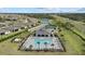 Aerial view of the community pool with lounge chairs, landscaping, and clubhouse for relaxation and social activities at 2000 Gardenia Ave, Port Charlotte, FL 33953