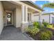 Charming front porch sitting area with stone columns and manicured garden at 2000 Gardenia Ave, Port Charlotte, FL 33953