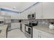 Bright kitchen featuring granite counters, stainless appliances and decorative backsplash at 2000 Gardenia Ave, Port Charlotte, FL 33953
