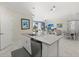 Open kitchen with granite countertops, stainless steel dishwasher, and view into living and dining areas at 2000 Gardenia Ave, Port Charlotte, FL 33953