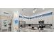 Modern kitchen with stainless steel appliances, white cabinets, granite countertops, and a kitchen island at 2000 Gardenia Ave, Port Charlotte, FL 33953