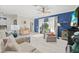 Bright living room featuring marble floors, a ceiling fan, and comfortable seating near a large window at 2000 Gardenia Ave, Port Charlotte, FL 33953