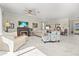 Open living space featuring a fireplace, ceiling fan, and seamless flow to the dining area at 2000 Gardenia Ave, Port Charlotte, FL 33953