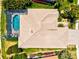 Overhead view of a home with a pool, lanai and manicured landscaping at 20126 Elegante Ct, Venice, FL 34293