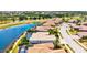 Aerial image featuring a waterfront property with a screened pool and lush landscaping at 20126 Elegante Ct, Venice, FL 34293