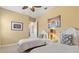 Comfortable bedroom has twin beds, ceiling fan, and beach-themed decor at 20126 Elegante Ct, Venice, FL 34293