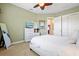 Inviting bedroom featuring a white dresser, large closet, ceiling fan, and TV at 20126 Elegante Ct, Venice, FL 34293