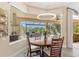 Breakfast nook with a view of the backyard, pool and seating at 20126 Elegante Ct, Venice, FL 34293