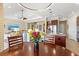 Open-concept living space with breakfast nook and a view of the modern kitchen at 20126 Elegante Ct, Venice, FL 34293