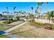 Beautiful entrance to Gran Paradiso, complete with flowers, landscaping, and Palm Trees at 20126 Elegante Ct, Venice, FL 34293