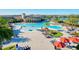 Resort-style community pool and clubhouse with ample seating, umbrellas and beautiful landscaping at 20126 Elegante Ct, Venice, FL 34293