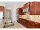 Sleek kitchen with rich cabinetry, stainless steel appliances, and granite countertops at 20126 Elegante Ct, Venice, FL 34293
