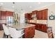 Well-appointed kitchen with granite counters, stainless steel appliances, and a center island with seating at 20126 Elegante Ct, Venice, FL 34293