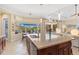Spacious kitchen island with seating overlooks screened lanai at 20126 Elegante Ct, Venice, FL 34293