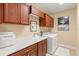 Functional laundry room with ample storage, sink, counter space, and modern washer and dryer at 20126 Elegante Ct, Venice, FL 34293